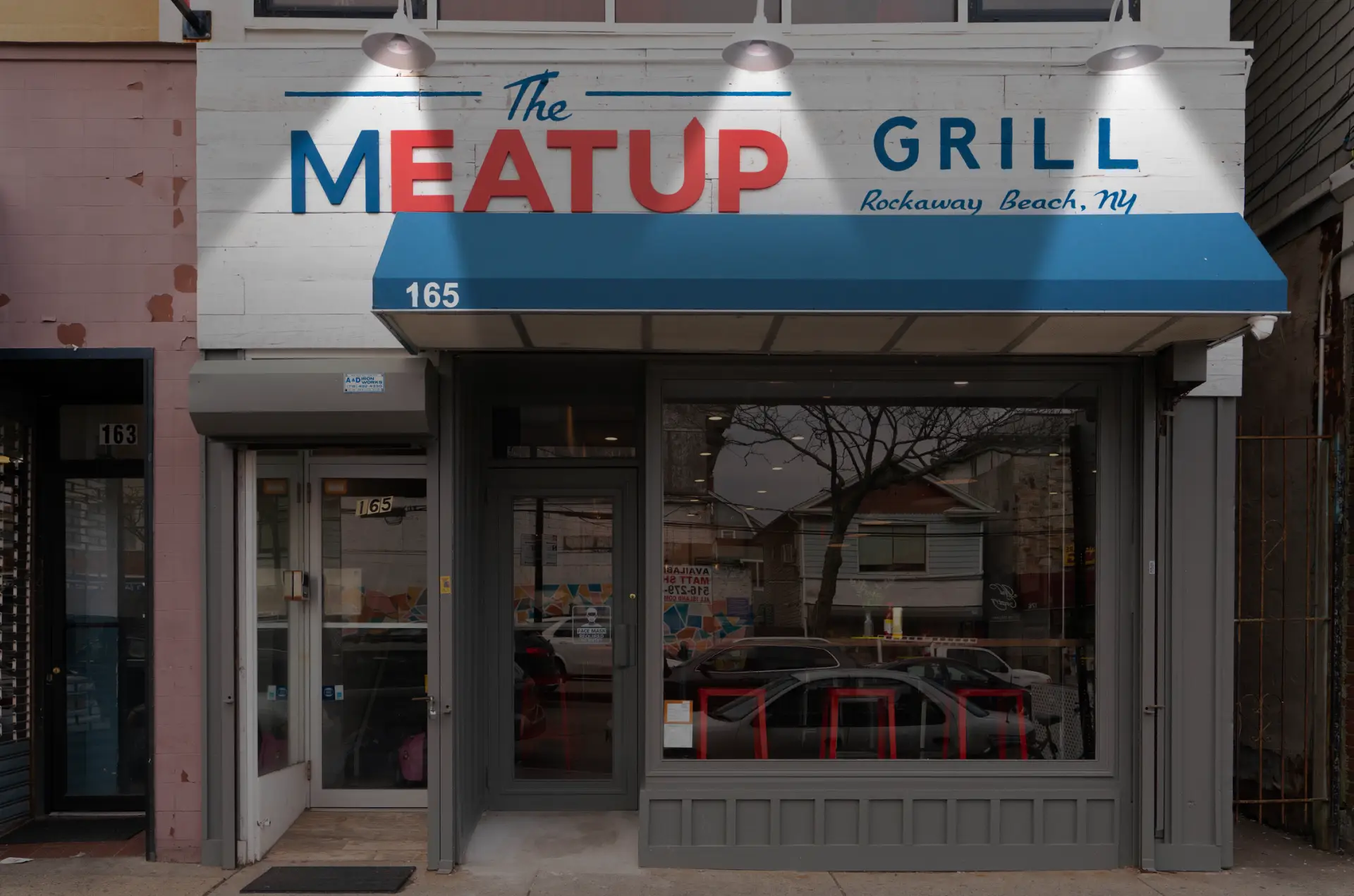 Exterior view of The Meat Up Grill restaurant storefront.
