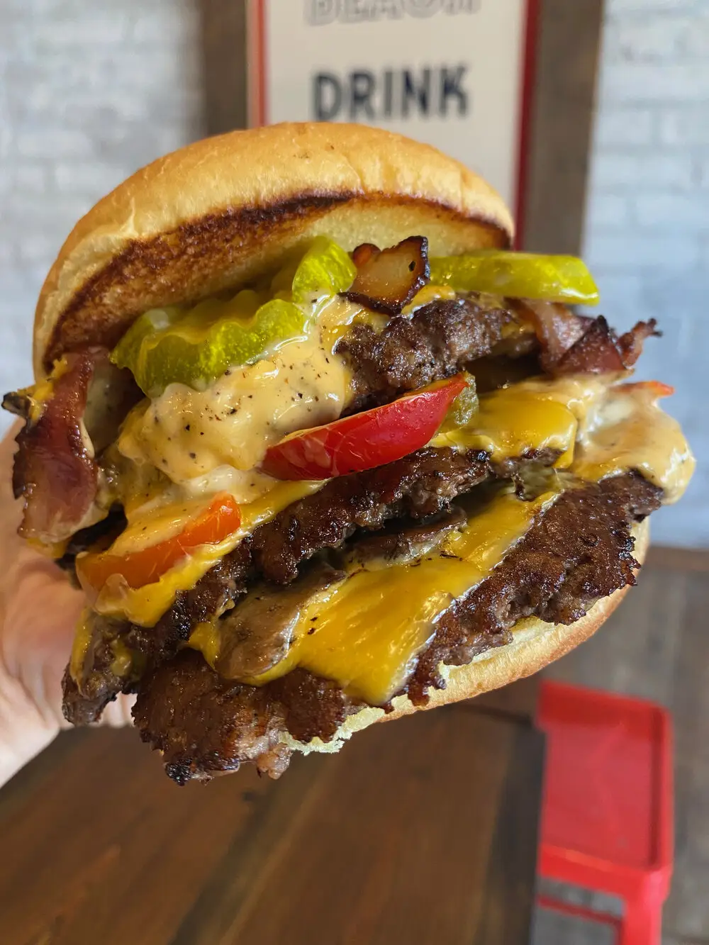 Juicy cheeseburger stacked with fresh toppings from The Meat Up Grill.